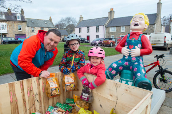 Nick, Matthew and Katie Pike collect potatoes from Floo'er Wullie in Fochabers.