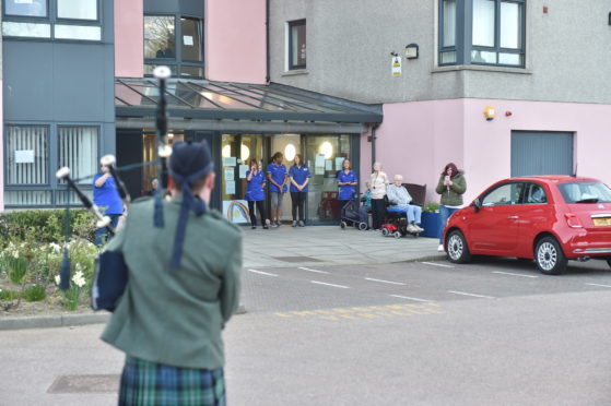 Jake Robertson piping outside Victoria Grange sheltered housing. Picture by Scott Baxter.