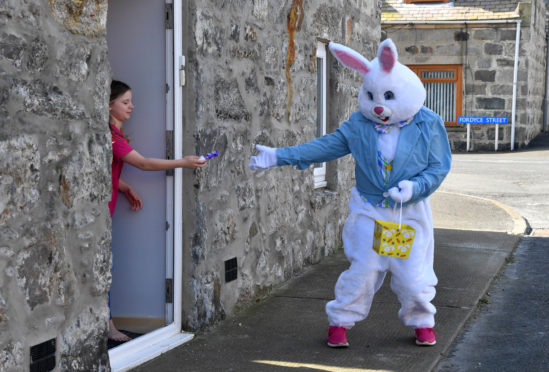 The Easter Bunny hands out chocolate eggs on the streets of Rosehearty.