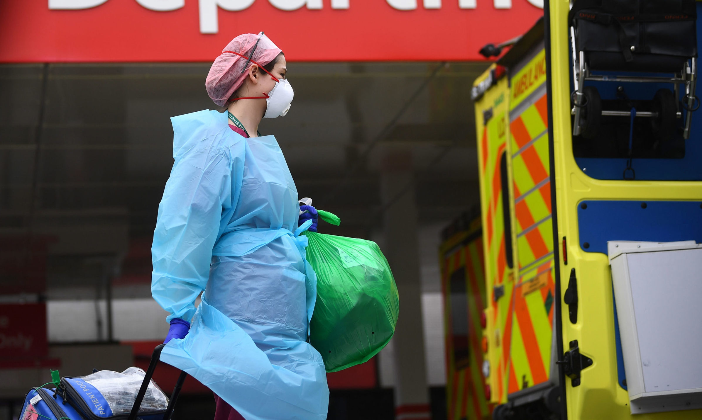 A member of hospital staff wearing personal protective equipment (PPE) outside St Thomas' Hospital in Westminster, London as the UK continues in lockdown to help curb the spread of the coronavirus.