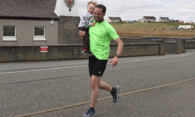 Despite two previous marathon completions, Chris (pictured with son Lachlan) said his latest run was a real challenge