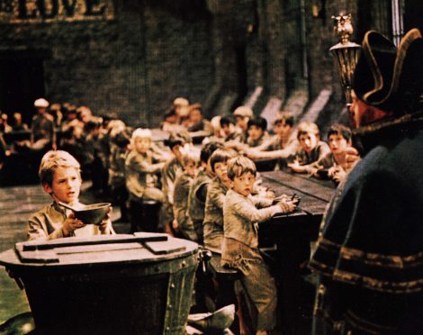 A memorable scene from the classic musical film as Oliver Twist – or Nicola Sturgeon? – steps up with his begging bowl in the 
workhouse to plead for more gruel