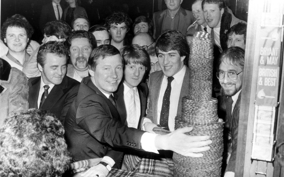 Dons manager Alex Ferguson, midfielder Gordon Strachan and striker Mark McGhee get set to demolish a pile of pennies for charity at the Grampian Bar, Torry, 
in 1983. The cash went to the Phoenix Youth Club, Torry.