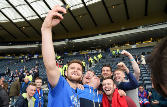 Danny Devine celebrates with the fans after winning the 2015 Scottish Cup.