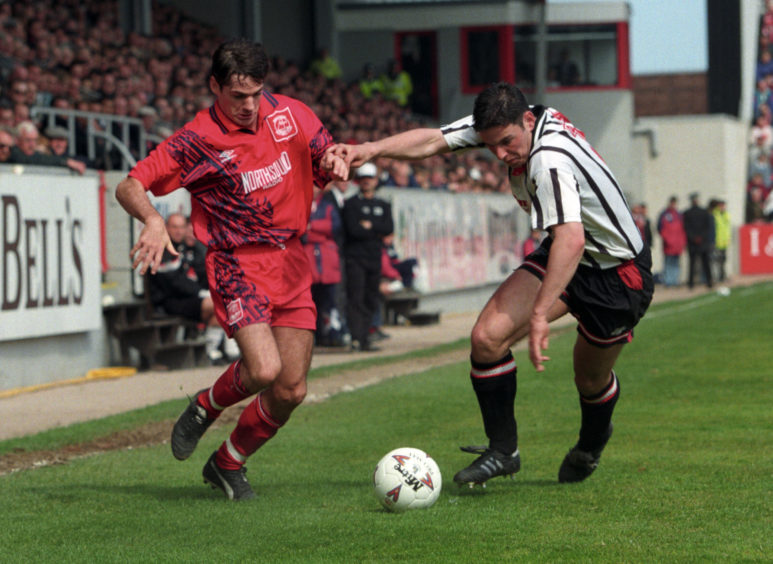 Joe Miller goes past Dunfermline's Andy Tod.