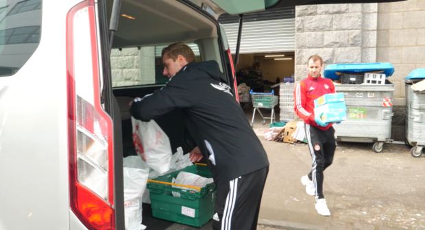 Aberdeen FC players deliver food parcels to vulnerable city residents.