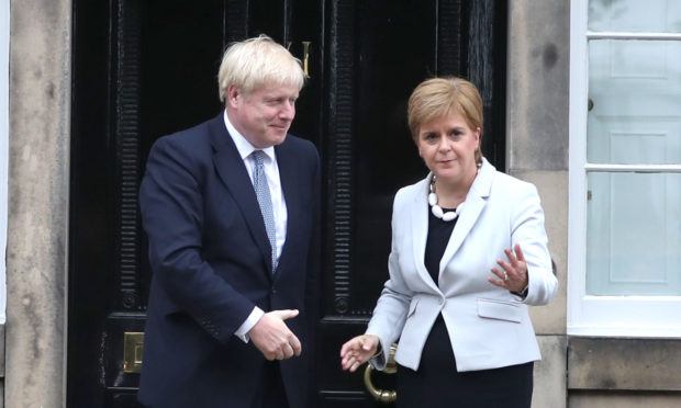 Scotland's First Minister Nicola Sturgeon welcomes Prime Minister Boris Johnson outside Bute House in Edinburgh.