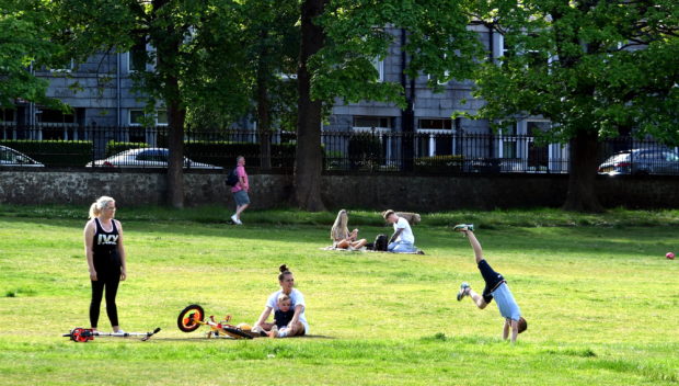 People enjoy the weather in Aberdeen's Westburn Park.