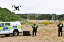 Police using a drone in the area of Feuchside, Deeside, Aberdeenshire in search for missing Robin Green.