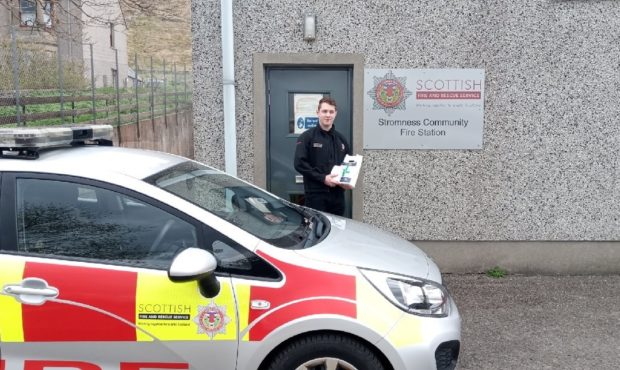 Firefighter Ross Harvey with prescriptions picked up from local chemist.