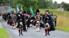 The Lonach Highlanders marching through Bellabeg.