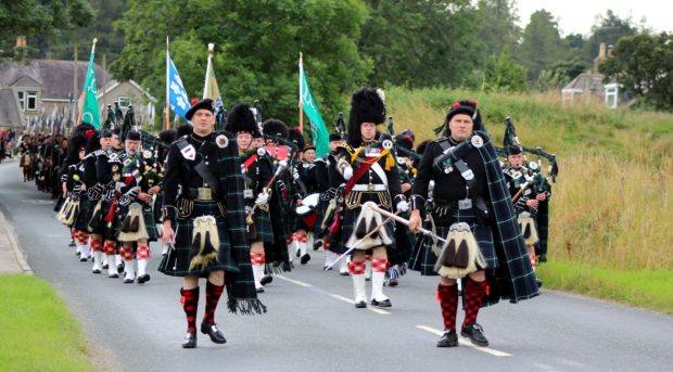 The Lonach Highlanders marching through Bellabeg.