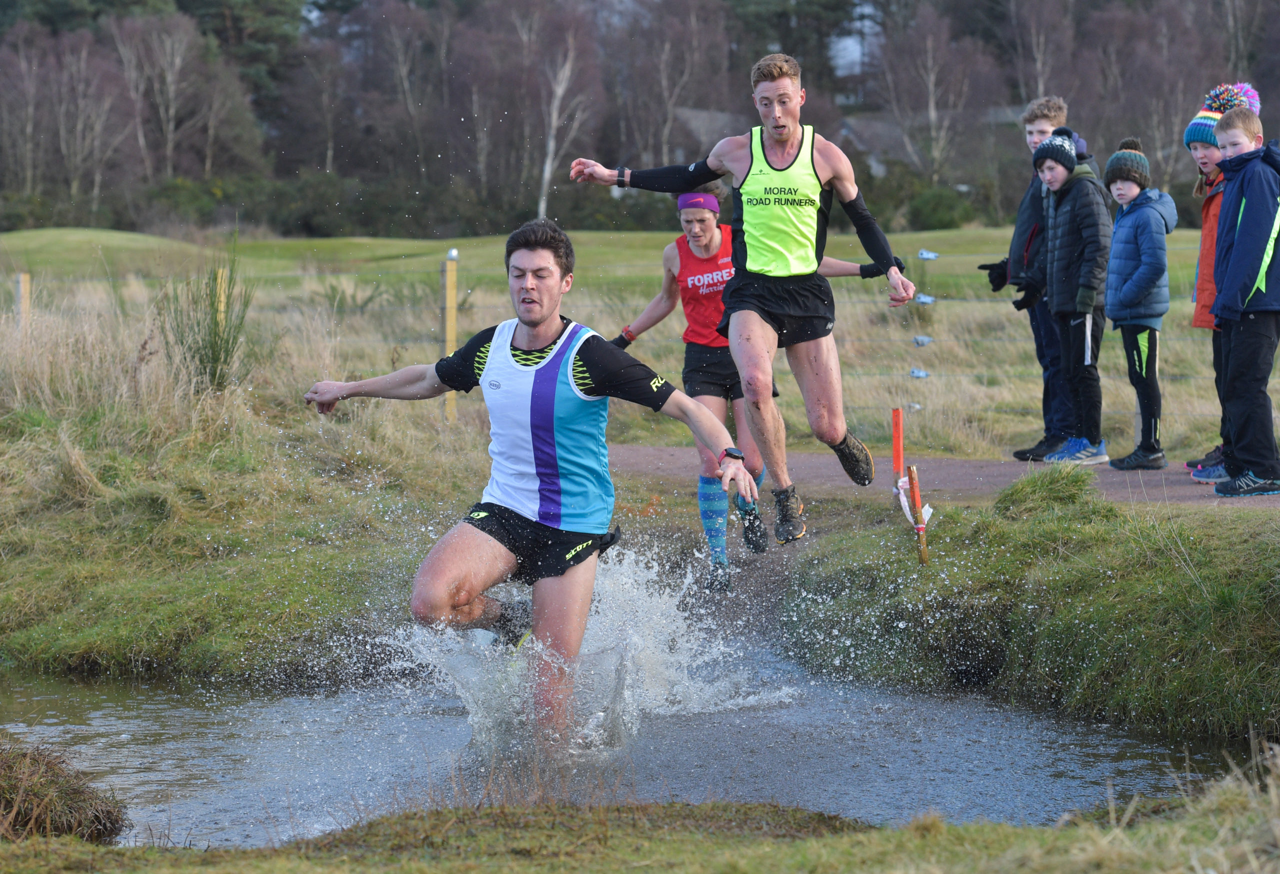 Ross Gollan being chased by Kenny Wilson through the water obstacle.
Pictures by Jason Hedges.