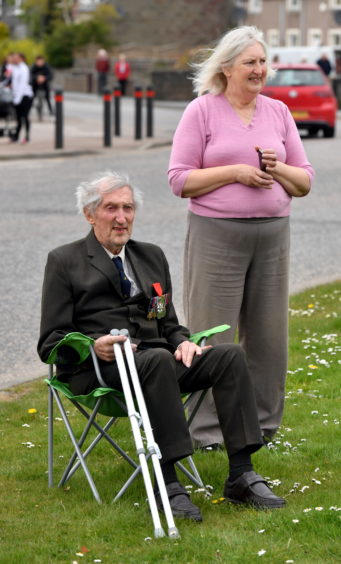 CR0021205
Pictured at Mintlaw listening to four members of the Buchan Peterson Pipe Band play at the war memorial for VE Day, Veteran Peter Davies ex Royal Artillery with his daughter Janes Knowles.    
Picture by Kami Thomson         08-05-2020