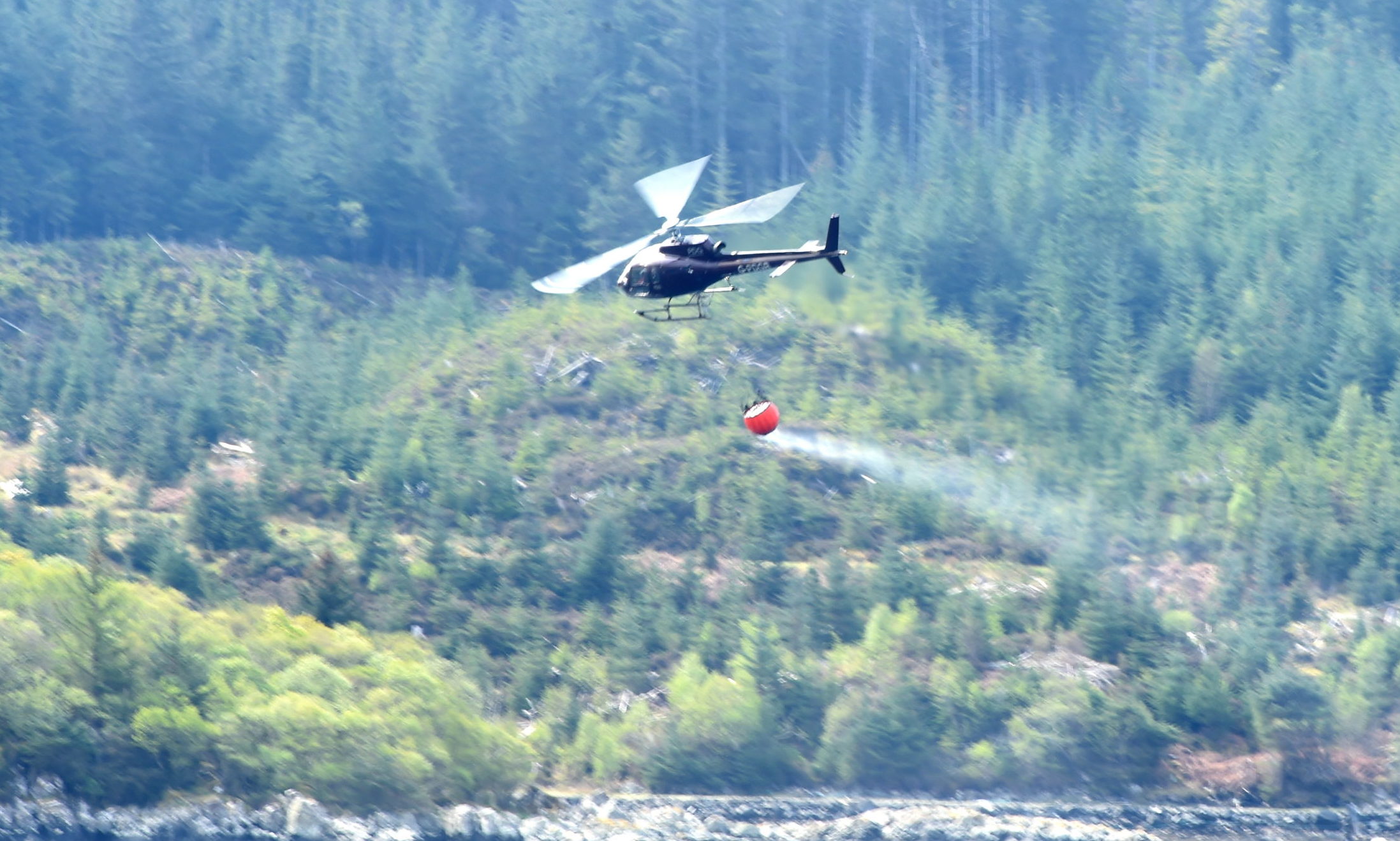 A helicopter is used to assist ground crews fighting the wild fire.
Picture by Sandy McCook.