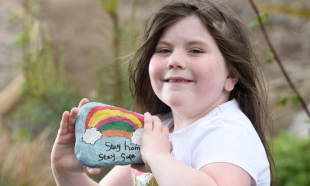 Charlotte Legge in the Natal Gardens , Invergordon with some of their hand painted pebbles.
Picture by SANDY McCOOK