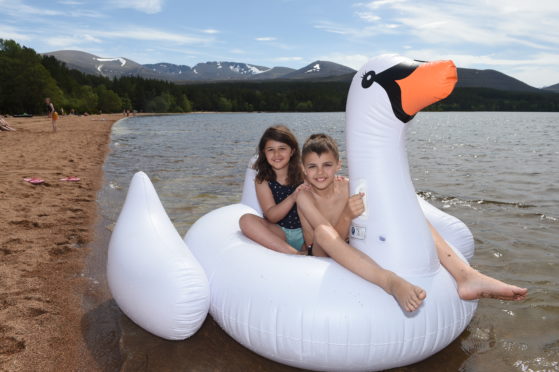 Brother and sister Zak and Chloe Messaoud playing on Loch Morlich.
Picture by Sandy McCook