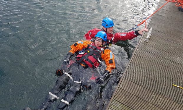 Photos of a rescue swimmer during training.