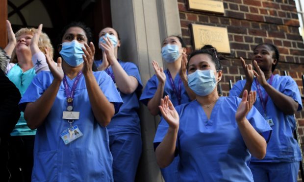 Medical staff from St Mary's Hospital in Paddington, London, take part in Clap For Our Carers in May 2020.