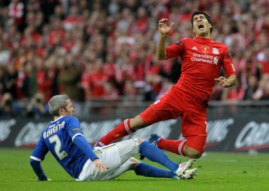 Cardiff City's Kevin McNaughton, left, tackles Liverpool's Luis Suarez during the English League Cup final in 2012.