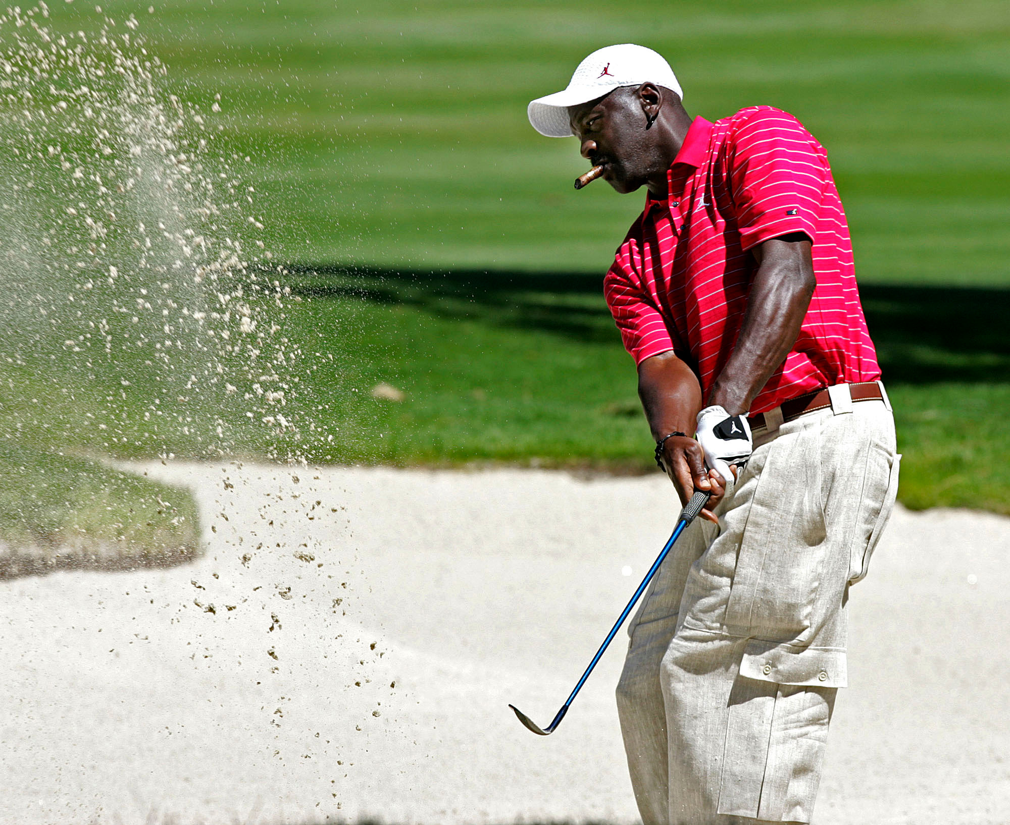 Michael Jordan hits out of a bunker on the 16th hole at Edgewood Tahoe Golf Course.