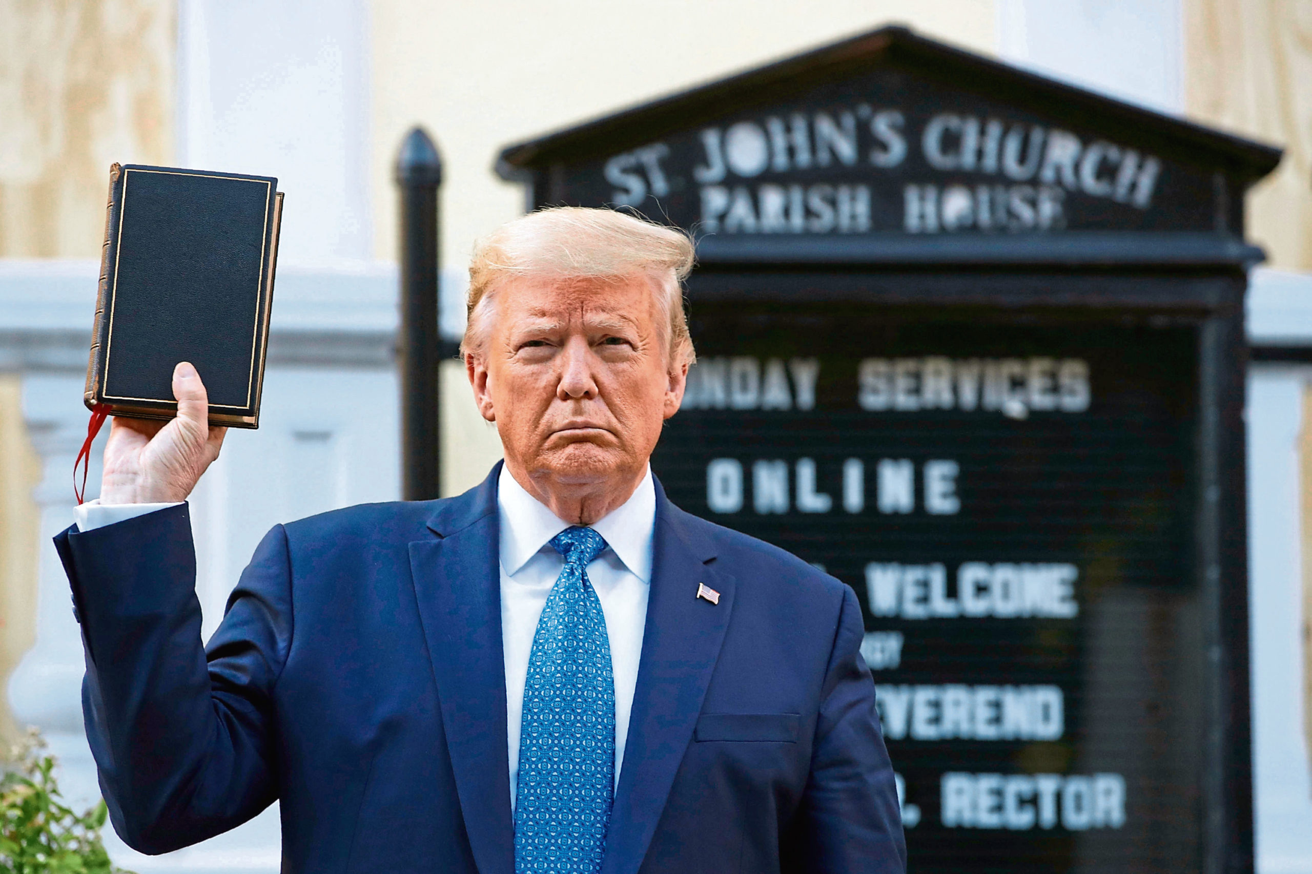President Donald Trump holds a Bible outside St John's Church across Lafayette Park from the White House.