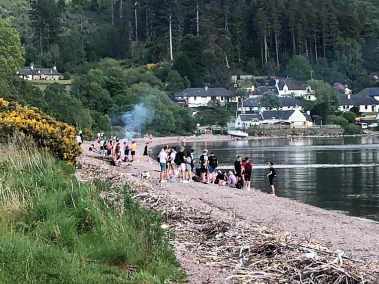 Youths gathered on the banks of Loch Ness