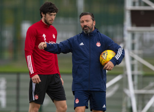 Aberdeen manager Derek McInnes with Scott McKenna at training.