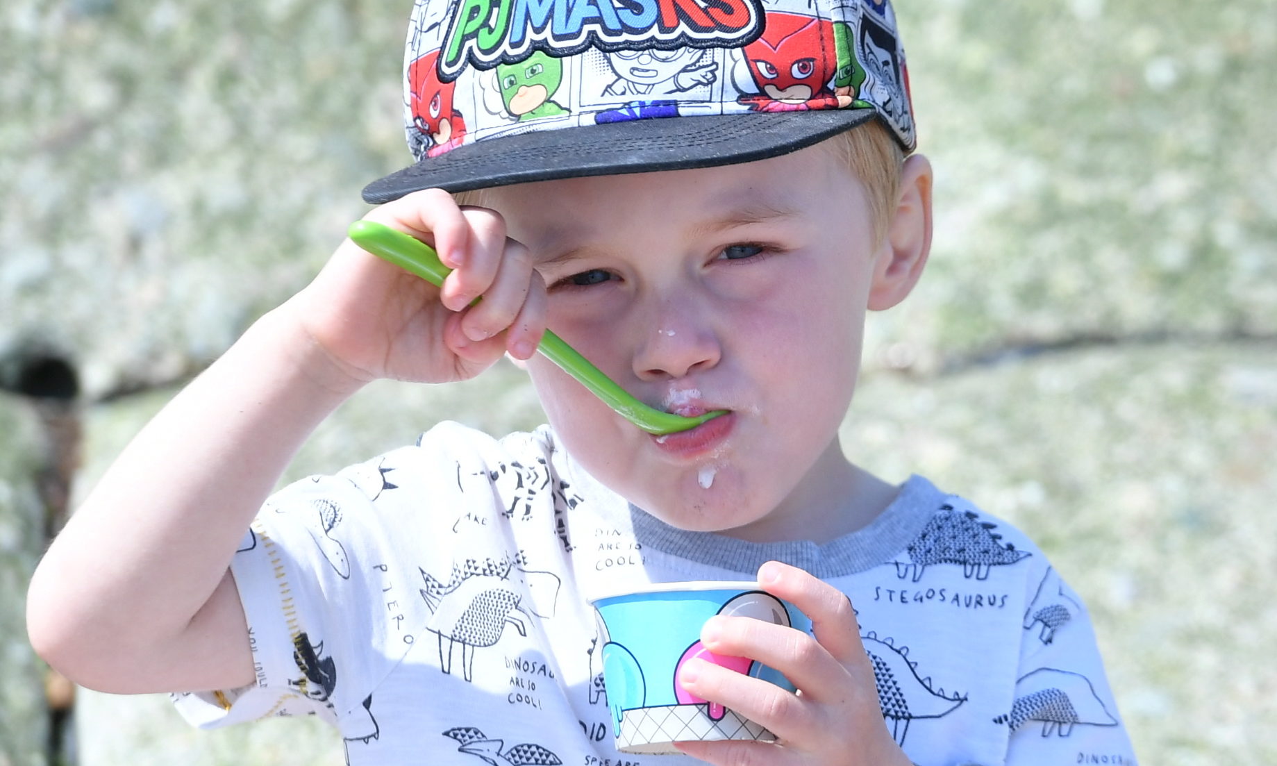 Three-year-old Charlie Shearer tucks into some ice-cream at Aberdeen beach. Photo by Chris Sumner