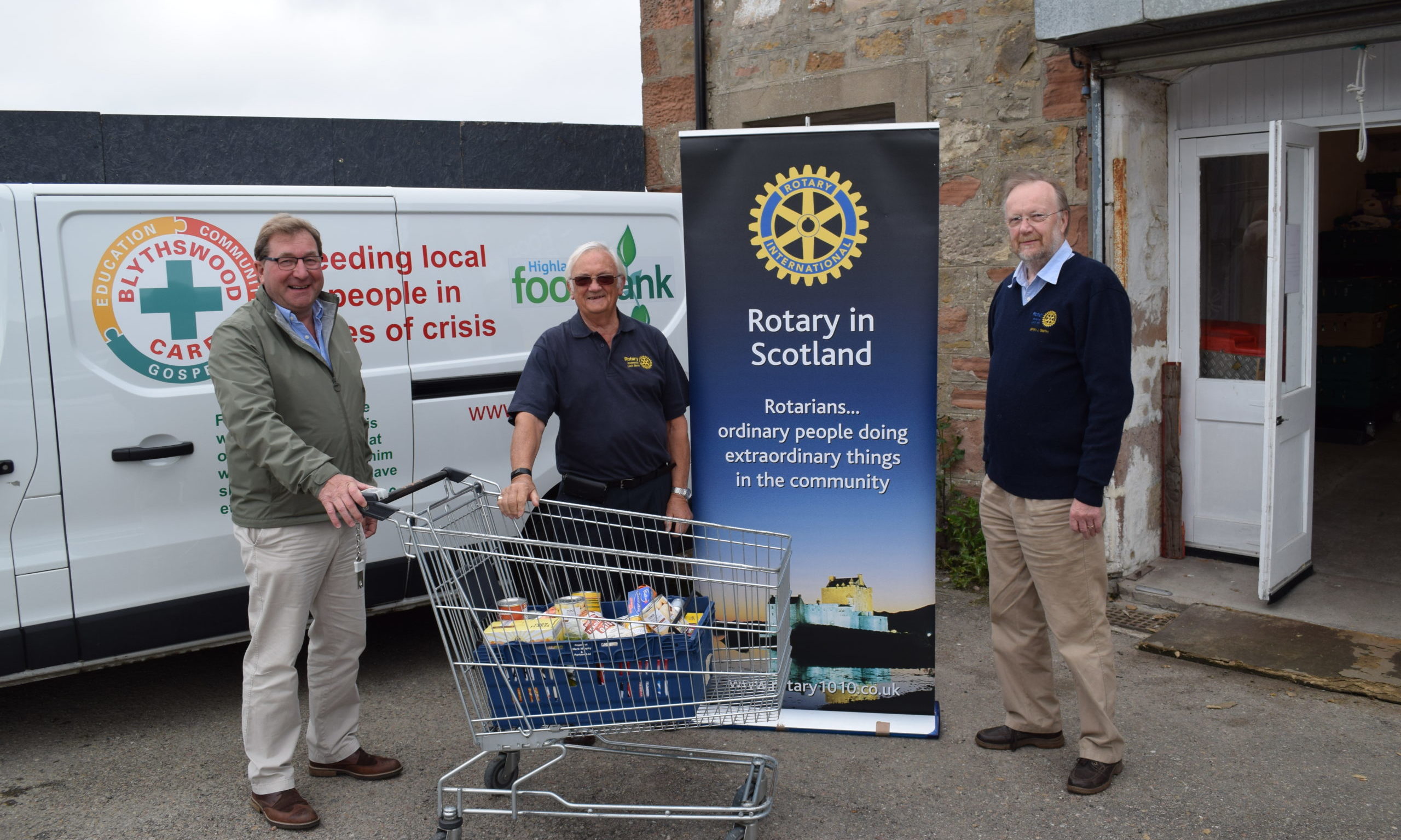 Blythswood chief executive James Campbell is delivered the £1,000 cheque by Mike Halley and Bryan Smith of the Rotary Club of Inverness Loch Ness