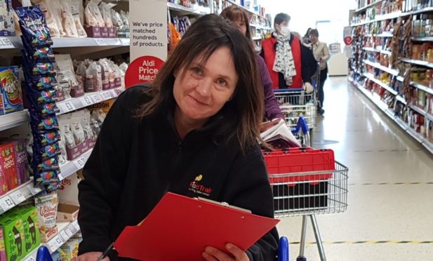 A Food Train volunteer carrying out a supermarket shop.