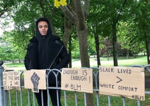 Funso Ojo with Black Lives Matter signs put up in Aberdeen.