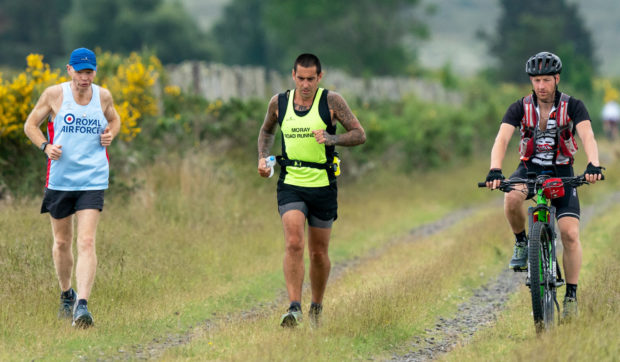 John Anderson, pictured centre, ran 100 miles to remember friend Jon Ward. Pictured left, Gareth Jenkins, right, Steven Morrison.