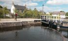 Trapped salmon smolt are being netted at Muirtown Lock in order to be released into the River Ness to continue their journey to the sea