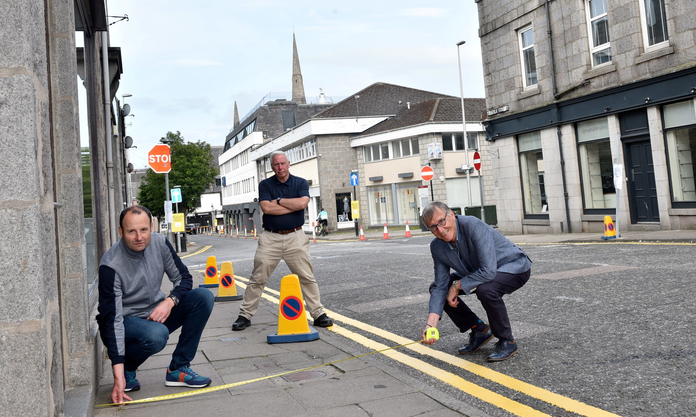 Mark (left) and Norman Esslemont (right) of Esslemonts measure the width of the pavement in Thistle Street, as Rob Goldie of Baskin-Robbins looks on.
Picture by DARRELL BENNS