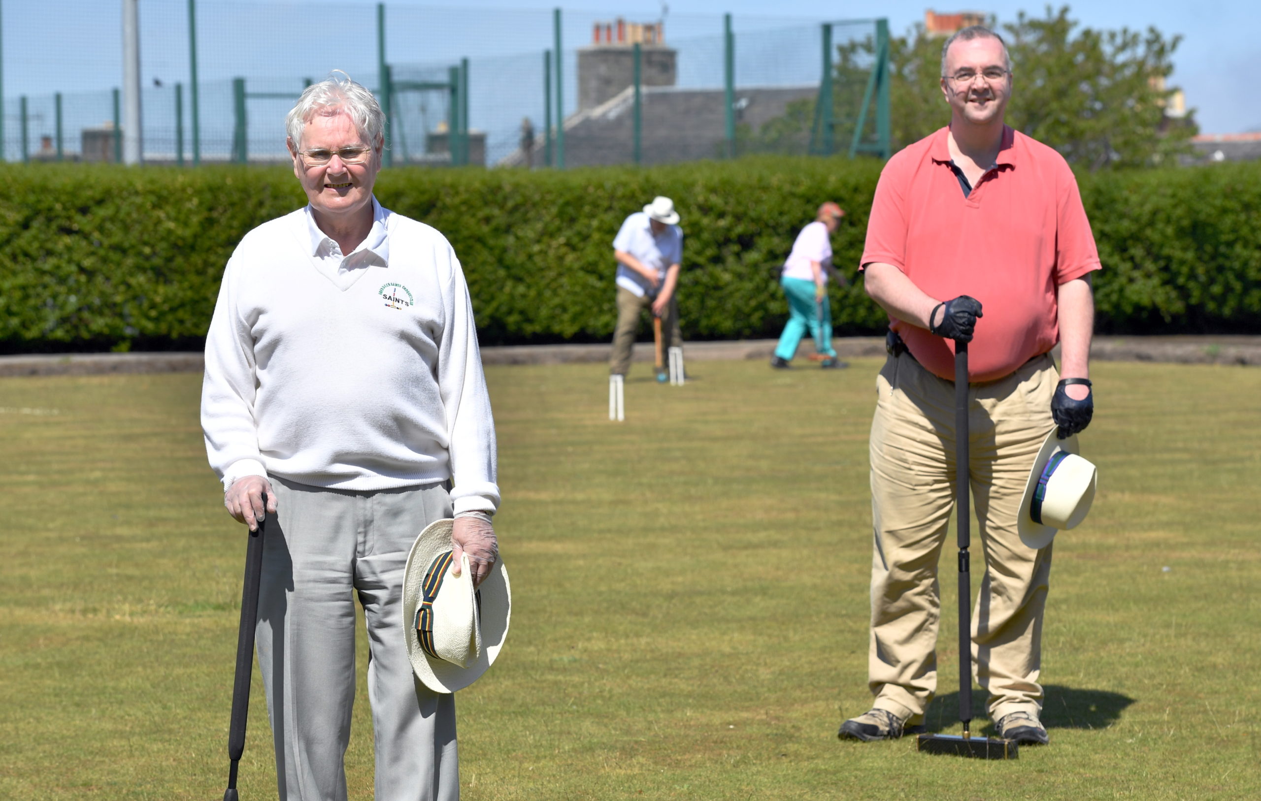 CR00221582     
Coronavirus / Covid19 ; 
Now that the lockdown has been eased, because we have entered phase one the paying of croquet is now allowed with some restrictions and social distancing. So members of the Aberdeen Saints Croquet Club have returned to their game at the Torry Outdoor Sports Centre, Victoria Road.     
Pictured - Club captain Charles Henderson (left) with club secretary Quentin Stephens as Ralph Rotheroe and Pamela Rotheroe-Hay play.    
Picture by Kami Thomson         01-06-2020