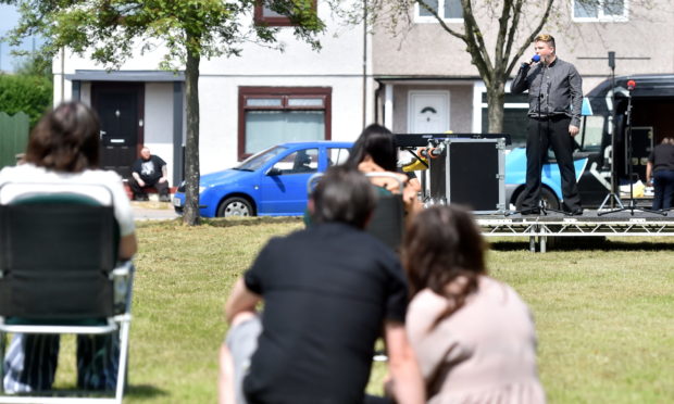 Lewis Carroll on the stage as residents watch on.

Picture by Scott Baxter