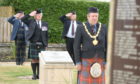 Lt Col Bob Towns leads the salute at the war memorial as Councillor Laurie Fraser lays a wreath. Picture by Sandy McCook