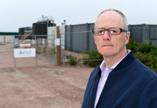 Ardersier campaigner Clive Meredith with the larger than expected tank and gantry at the currently under construction new Ardersier waste water treatment plant in Ardersier.
Picture by Sandy McCook