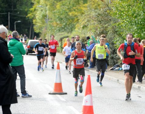 Runners during the 2018 marathon passing through Dores on the shores of Loch Ness. Picture by Sandy McCook