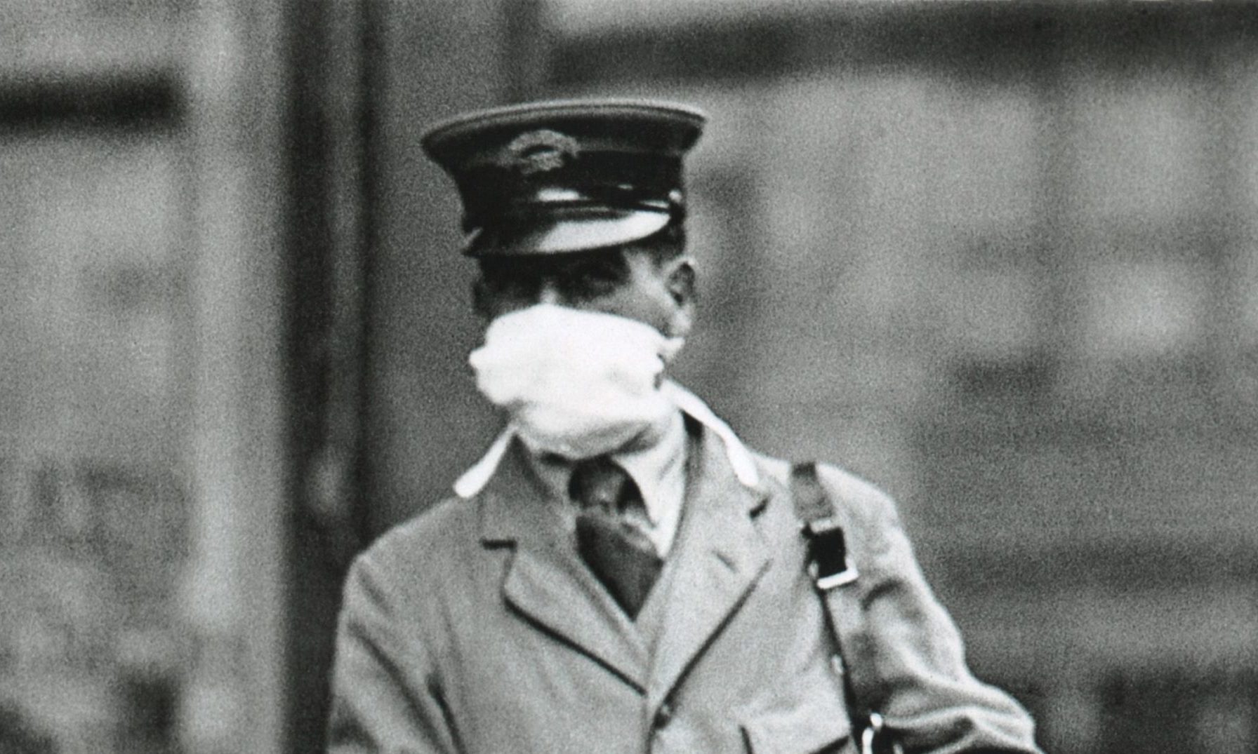 A letter carrier in New York City wearing a gauze mask to avoid catching influenza. in 1918.