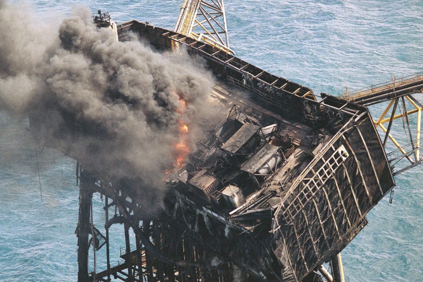 Thick smoke and flames still rise from the mangled remains of the Piper Alpha oil platform in the North Sea off the coast of Scotland in Aberdeen, July 8 1988.