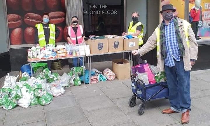 Justin Ritchie (right) and the Street Friends Helping The Homeless volunteers at their table in St Nicholas Street, outside Marks And Spencer.