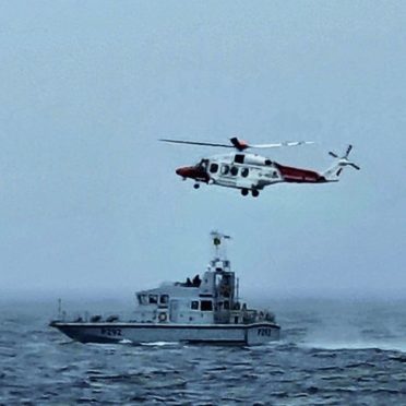 HMS Charger conducting search and rescue training with the Stornoway Maritime and Coastguard Agency helicopter.