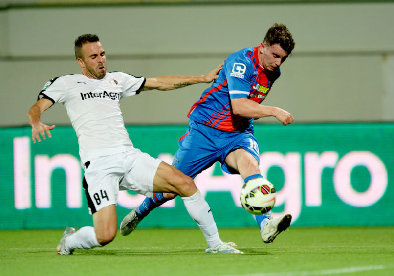 Aaron Doran (right) is challenged by Astra's Pedro Queiros.
