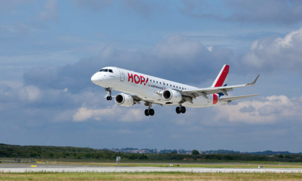 An Air France Hop Embraer aircraft leaves the tarmac.