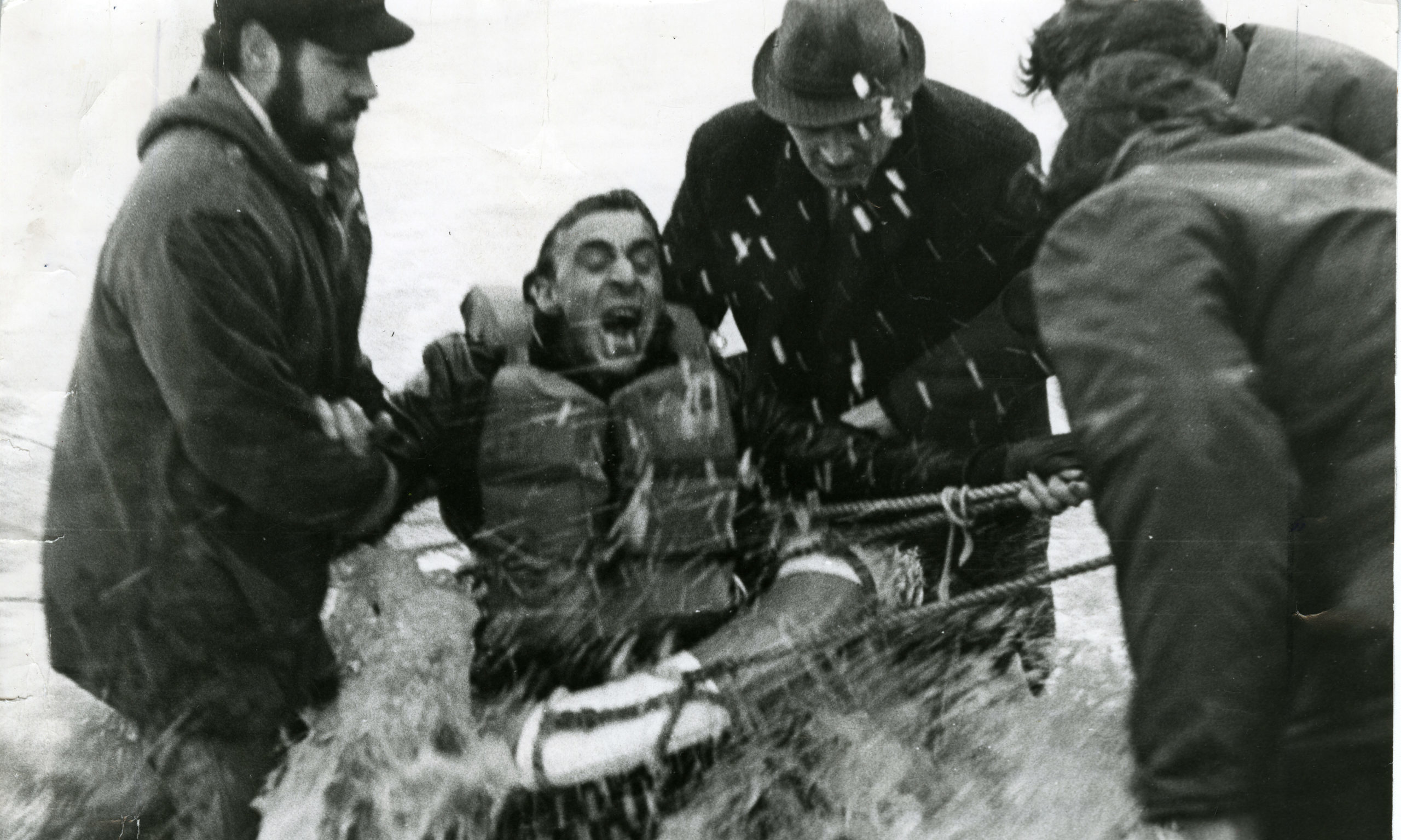 A crew member of the Polish trawler "Nurzec" screams in agony because of the freezing water as rescuers wade in to remove him from the Breeches Buoy off the Aberdeen coast.