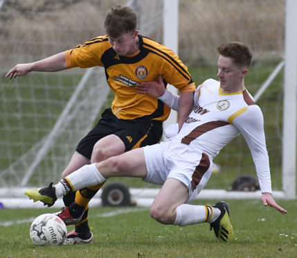 John Treasurer (left) tangles with Andrew Macrae, then of Forres Mechanics
