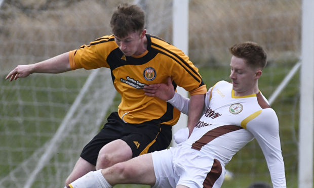 John Treasurer (left) tangles with Andrew Macrae, then of Forres Mechanics