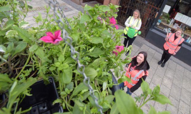 Members of the Fort William Town Team (left-right) Karen Dean, Deneil King and Cathy  Day brightening up Fort William High Street with hanging baskets.